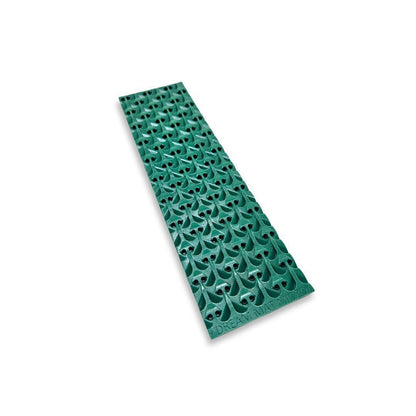 Angled view of green Micro Dream Mat 2nd Gen for Buddy showcasing repeating raised riffles and holes on white background