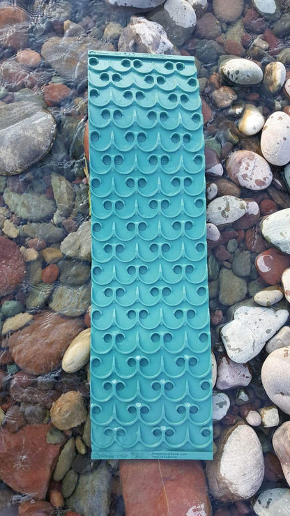 Top view of 10X36 Sluice Mat - Vortex Dream Mat showcasing repeating riffle channels in a shallow rocky stream
