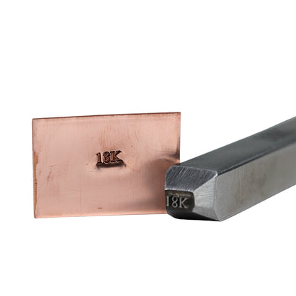 Angled view of Jewelers Metal Stamp showcasing 18K hallmark impression with hardened steel stamp on a white background
