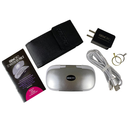 Top view of GEMORO CZ Master Set Pro 3 kit with silver case, black pouch, adapter, USB cord, rings, and manual