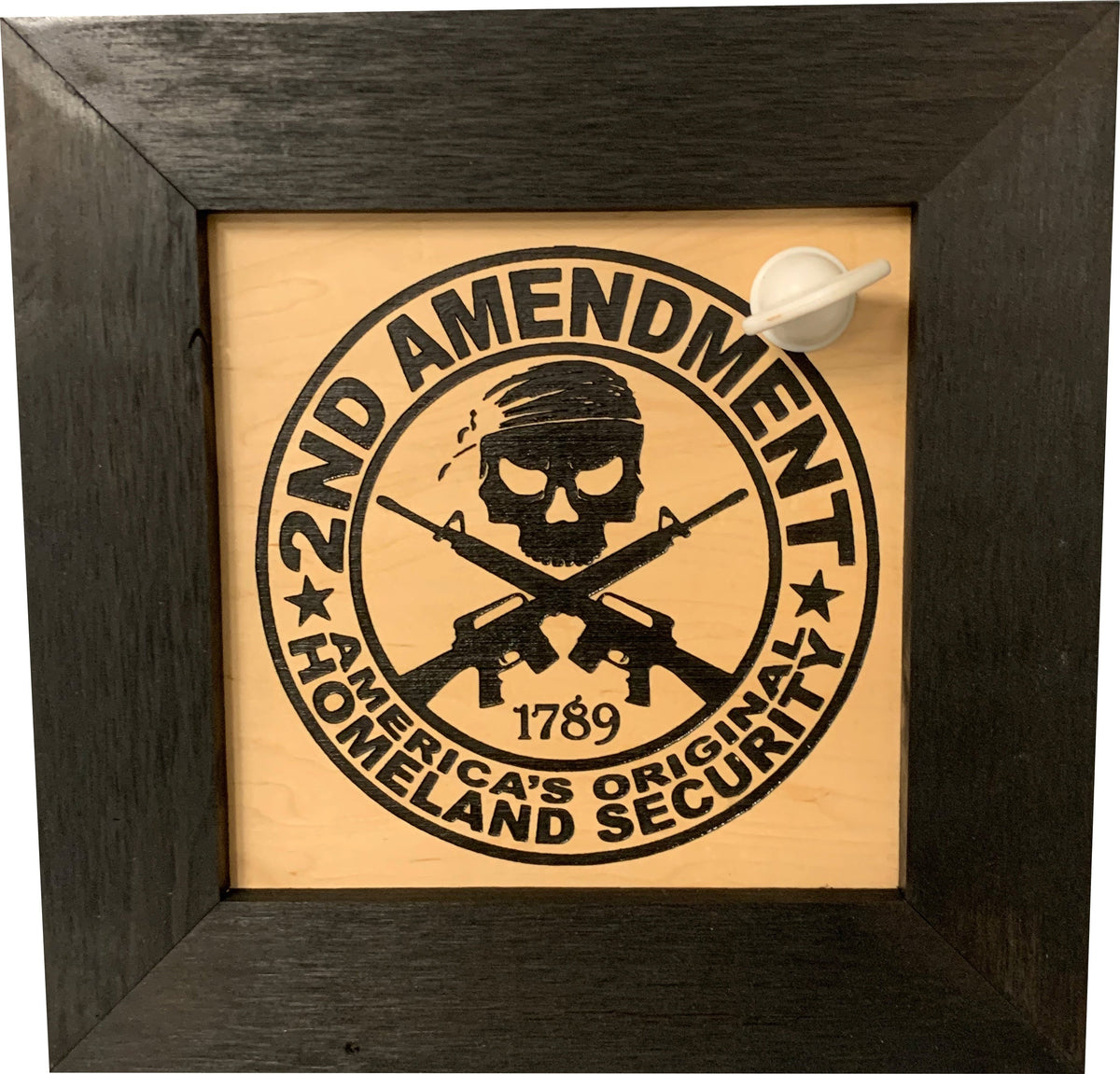 Black wooden framed sign with "2ND AMENDMENT" and "AMERICA'S ORIGINAL HOMELAND SECURITY" text, skull, and crossed rifles.