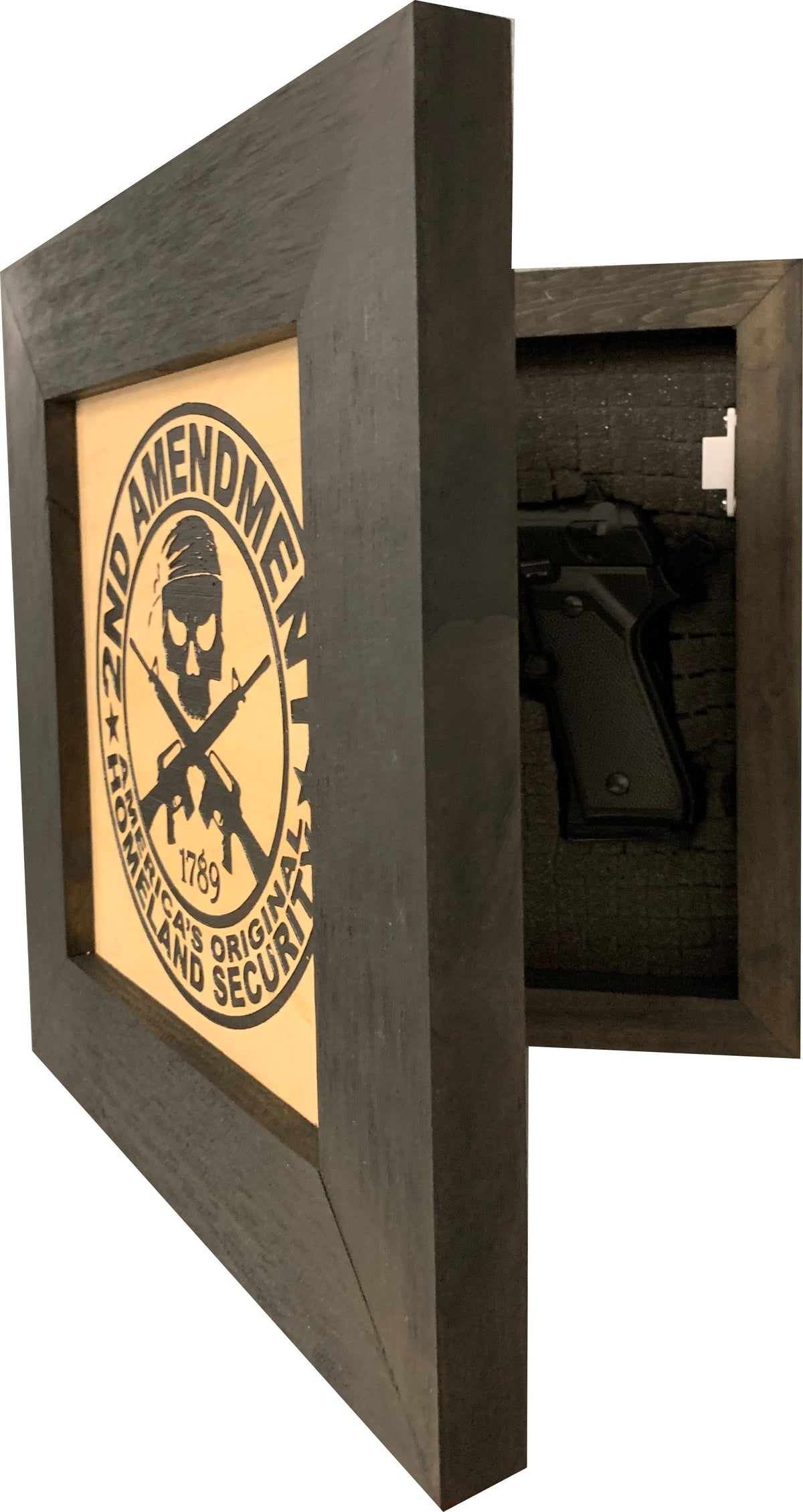 Dark wooden wall safe with a tan front panel featuring a skull logo and "2nd Amendment" text, open to reveal a black pistol.