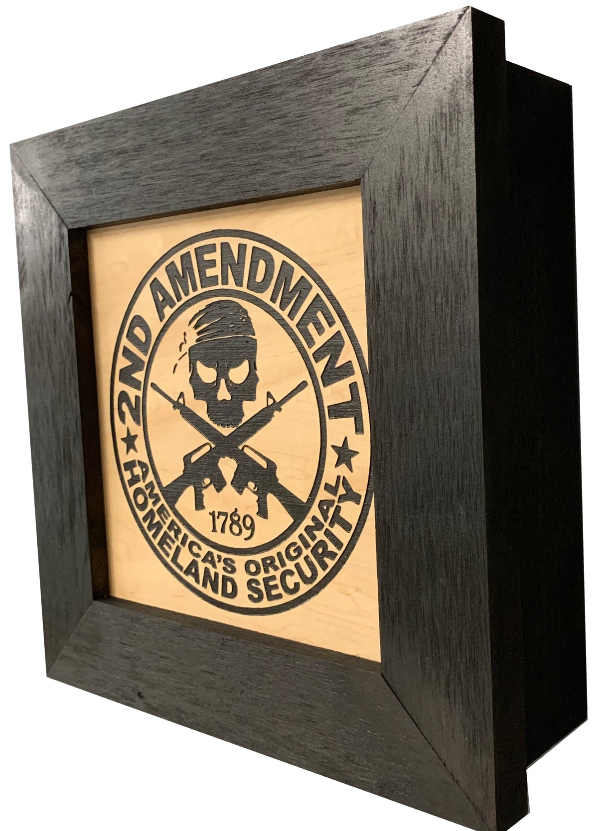 Black wooden square wall safe with laser-engraved 2nd Amendment skull and cross rifles design on light wood face.