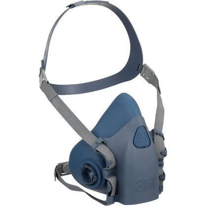 Three-quarter view of 3M 7500 Series half face reusable respirator with blue-gray mask and straps on white background