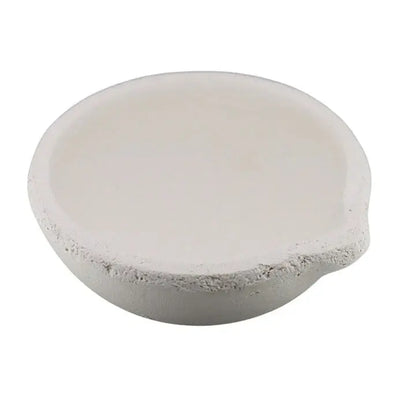Close-up of a small ceramic crucible showcasing its shallow white bowl shape with a white background