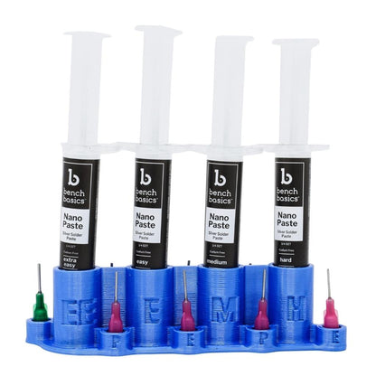 Front view of blue organizing stand for paste solder showcasing four labeled syringes and applicator tips on white background