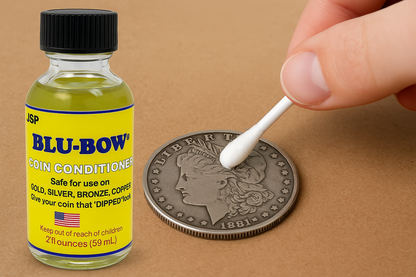 Front view of JSP Blu-Bow 2 oz Coin Conditioner Cleaner showcasing coin cleaning with a cotton swab on a brown surface