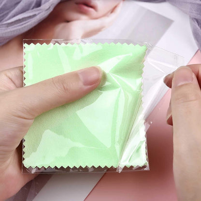 Close-up of the green cloth in clear packaging held by hands