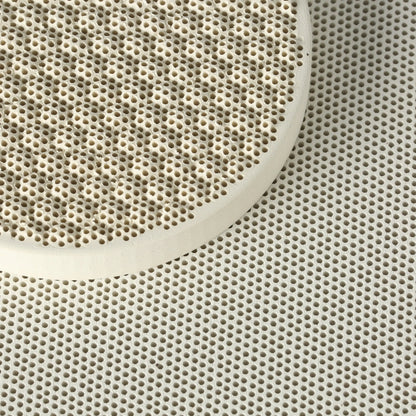 Close-up of Honeycomb Ceramic Soldering Blocks showcasing dense honeycomb perforations with one round block overlapping another