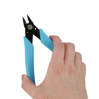 Close-up view of Xuron Micro-Shear Flush Cutter 170 II showcasing blue handles and black flush cutting jaws with a hand