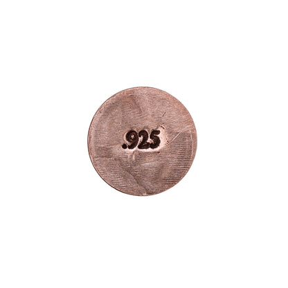 Close-up of a jeweler’s metal stamp showing a 925 hallmark on a round metal surface against a white background