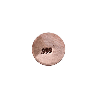Jewelers metal stamp imprint showing 999 on a round metal sample against a white background