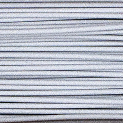 Close-up of Metal Filamet sample showcasing parallel layered ridges on a light background