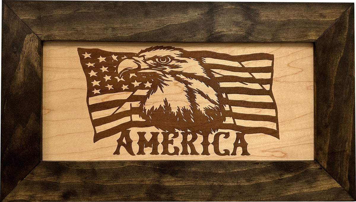 Framed laser-etched wooden sign featuring a bald eagle, American flag, and the text "AMERICA."