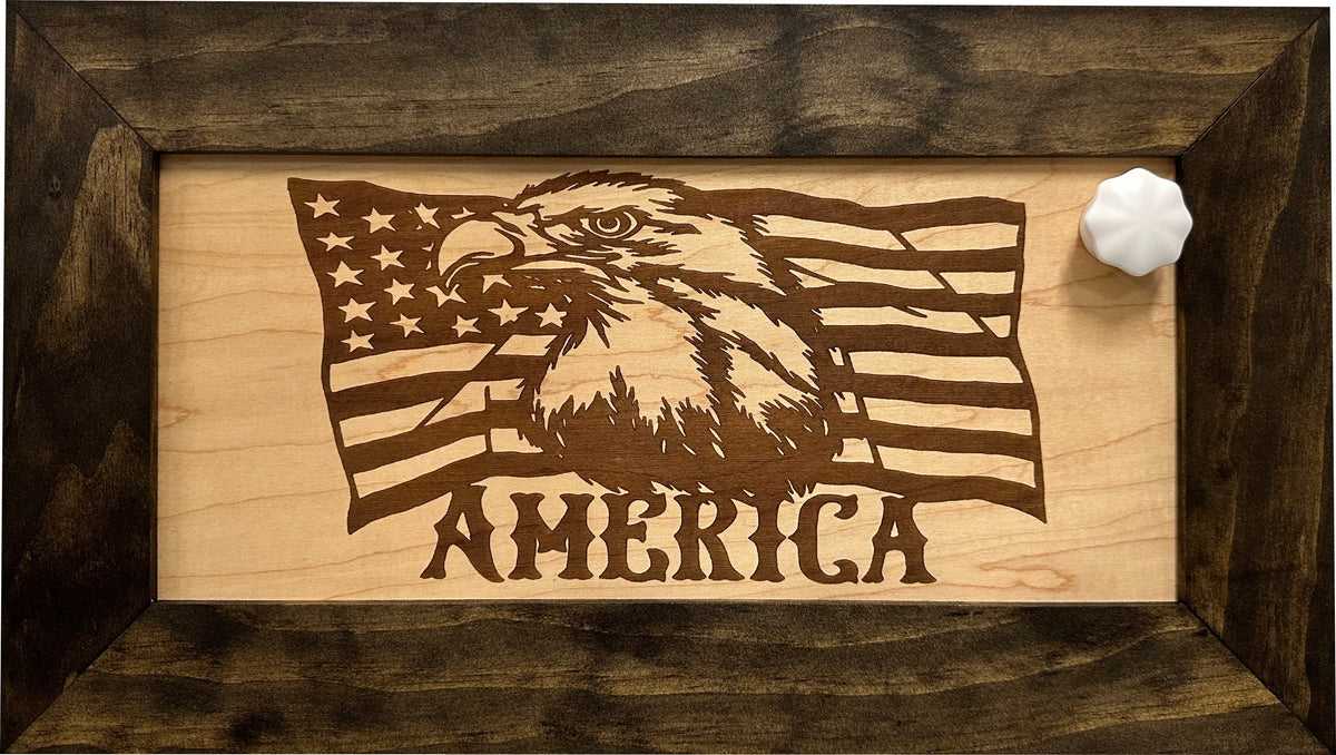 Wooden touchstone box with a dark frame, engraved eagle, American flag, and the word "AMERICA".