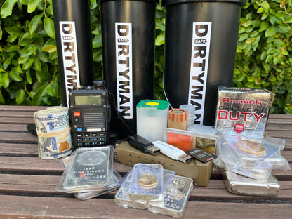 Front view of large DirtyMan Safe containers showcasing cylindrical storage with assorted valuables and equipment on a wooden bench