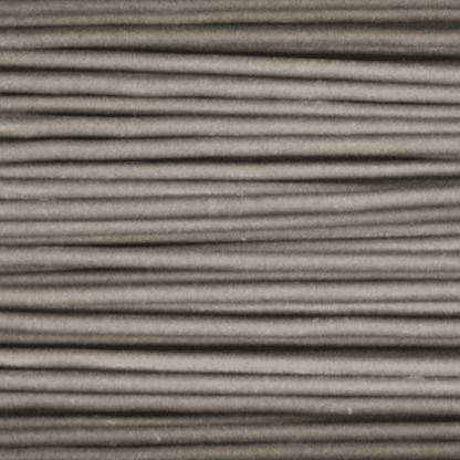 Close-up of Ceramic Filamet sample showcasing a gray, horizontally textured surface against a plain background