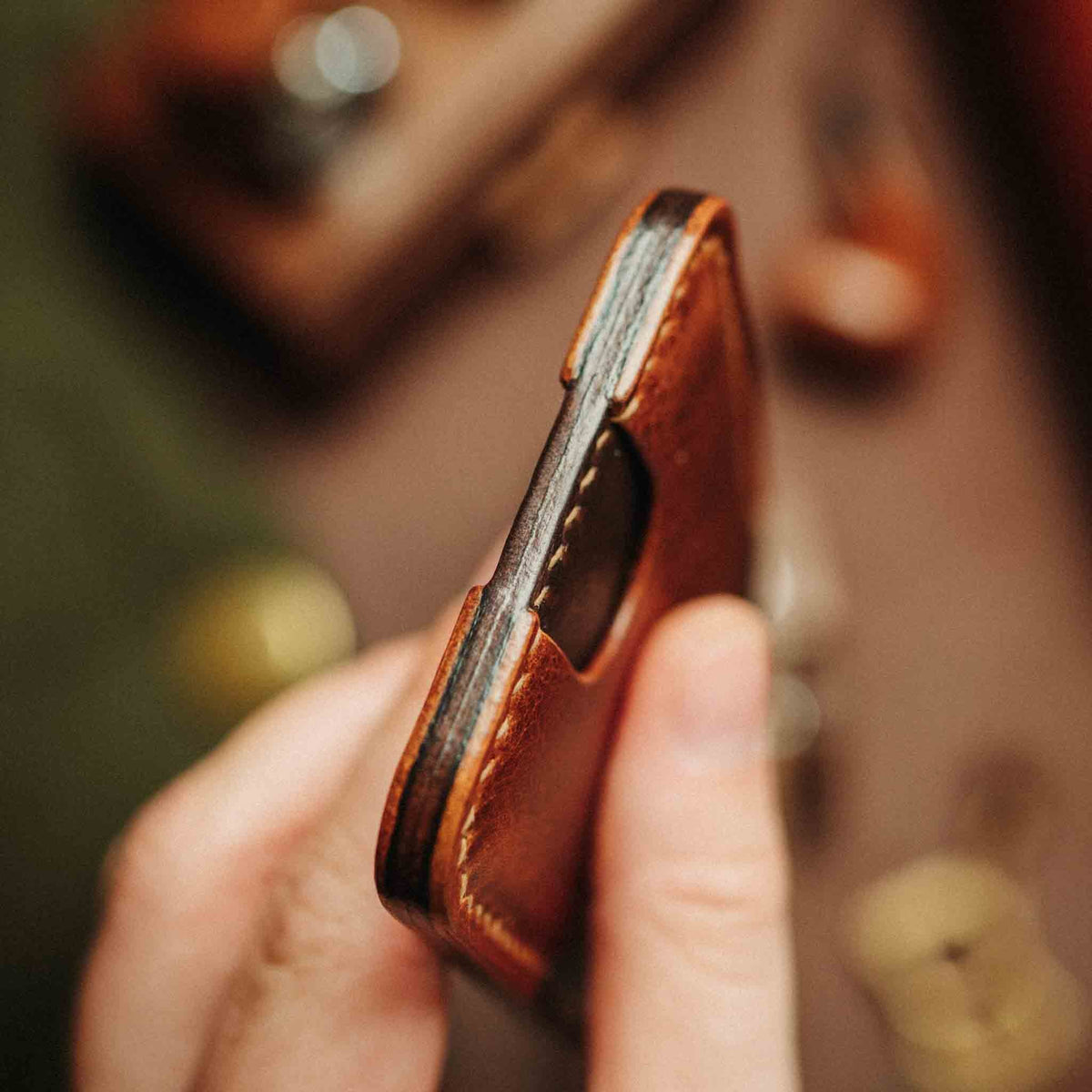 Side view of Pirate Goods Boatswain v4 Slim Wallet showcasing its slim brown leather profile held in hand