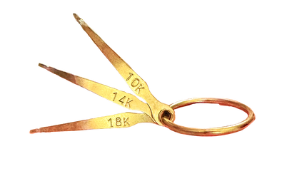 Close-up of GTE Gold Test Needles showcasing 10K, 14K, and 18K markings with a plain background