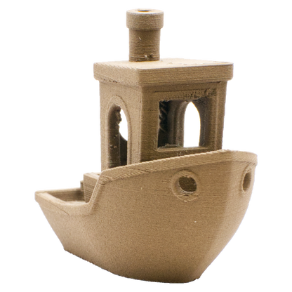 A small, light brown 3D-printed plastic boat model with a cabin, smokestack, and portholes.