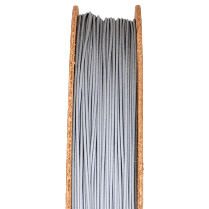 Front view of Aluminum 6061 Filamet spool showcasing tightly wound gray filament on a black background