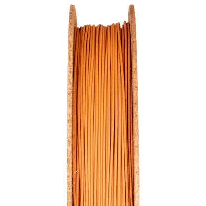 Close-up of Copper Filamet spool showcasing copper-colored filament between wood-toned flanges on a black background