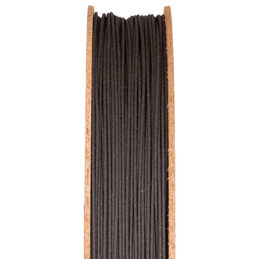 Front view of High Carbon Iron Filamet on a half-height cardboard spool showcasing dark filament