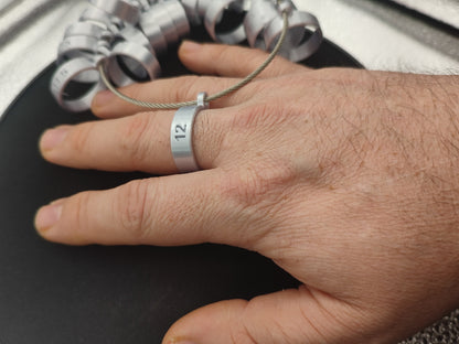 Close-up of SureFit 8mm Comfort Fit Ring Sizer Set showcasing a size 12 sizer worn on a finger with other sizers in background
