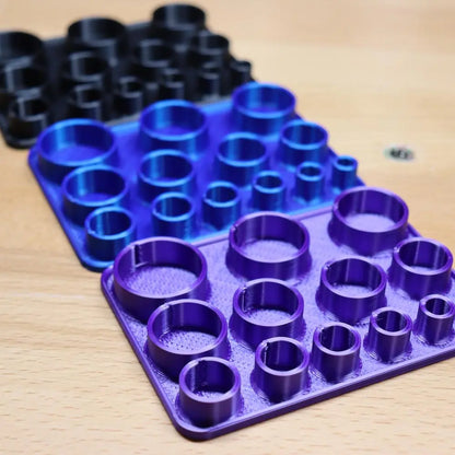 Close-up of 3D printed center positioning die holder for disc cutter showcasing multiple circular openings on a wood surface