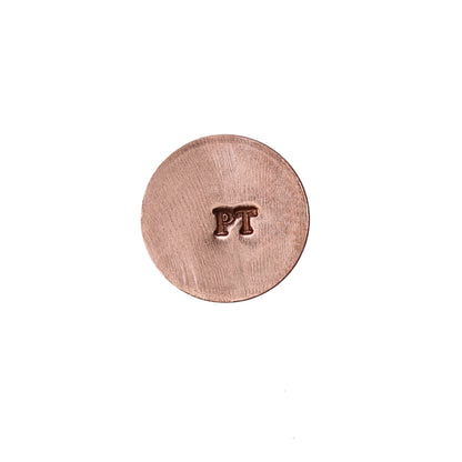 Front view of a round metal disc stamped with the letters PT on a white background