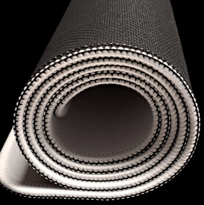 A tightly rolled, thick black testing mat with a textured surface and white stitched edges.