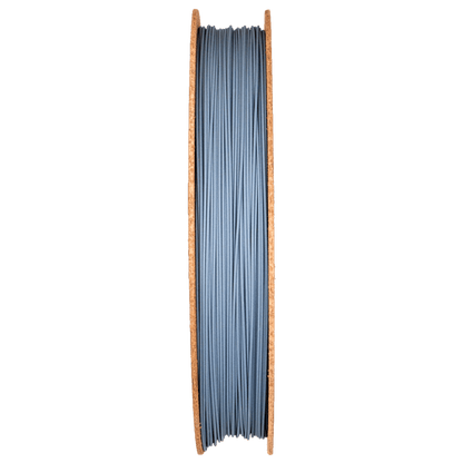 Front view of Silicon Carbide Filamet spool showcasing dark gray filament with copper-colored sides on a transparent background