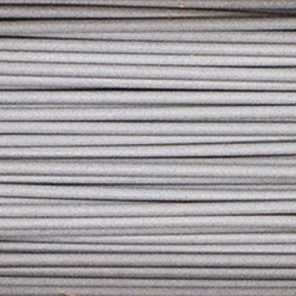Close-up of Metal Filamet Sample showing parallel gray metallic filament strands against a plain background
