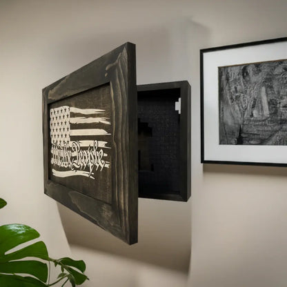 Angled view of an American flag wall-mounted hidden gun cabinet showing its open interior on a white wall