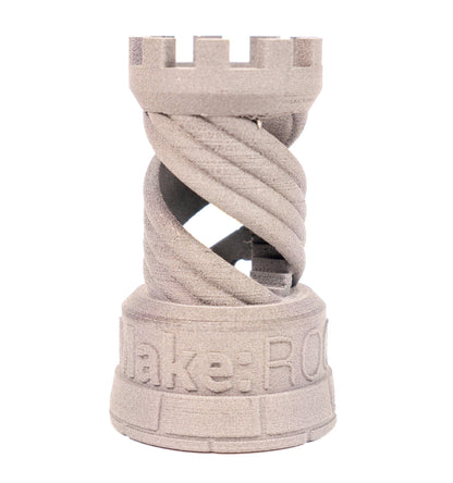 Front view of Aluminum 6061 Filamet 3D print showcasing a twisted open structure and castle top on a white background