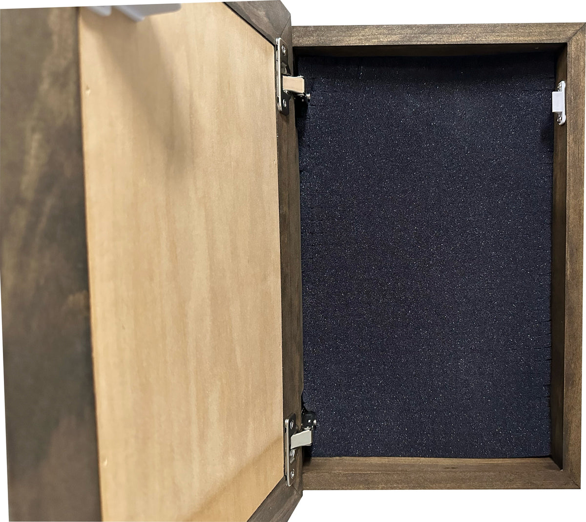 Open dark-brown wooden box with silver hinges and black foam lining inside.