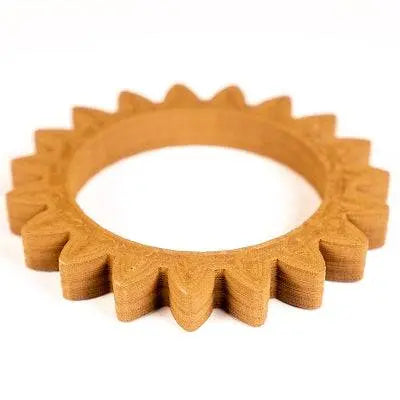 Angled view of Bronze Filamet showcasing a bronze-colored toothed ring with a white background