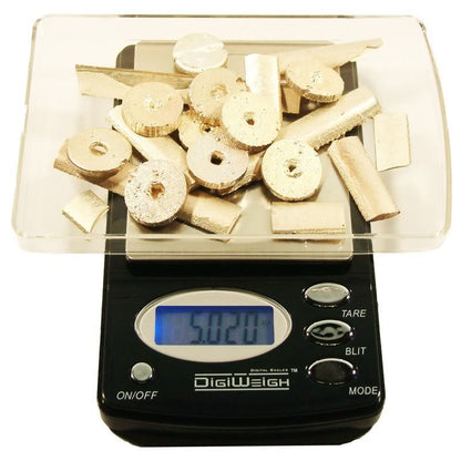 Front view of gold silver and platinum testing kit with digital scale showing 5.020 and metal pieces on a white background