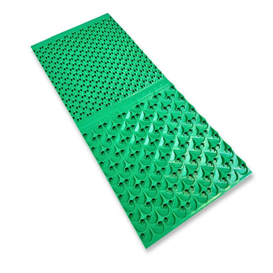Green rubber sluice box mat with textured riffles, featuring a fine-textured upper section and larger arrow patterns below.