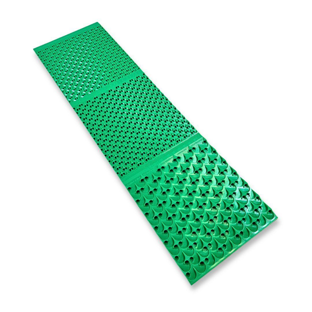 Long, narrow green rubber sluice box mat with varied riffle patterns.