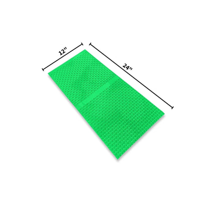 Angled view of 12X24 Micro Dream Mat - Big Foot Series with textured green surface and 12 and 24 inch markings on white
