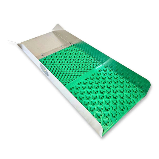 A silver metal sluice box with a vibrant green rubber mat featuring textured riffles for gold panning.