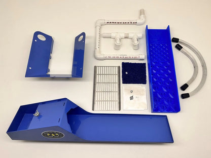 Top view of 4X16 Micro Banker with Dream Mat showcasing blue sluice box, grating, mat, fittings, and hoses on a white background