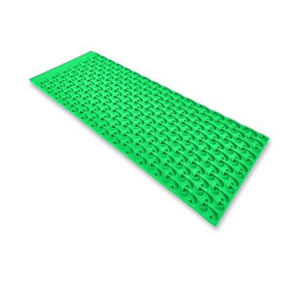 Angled view of 6X16 Micro Sluice Mat 2nd Gen Dream Mat showcasing its bright green repeating raised pattern on a white background
