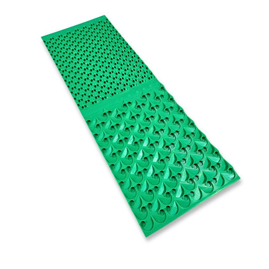 A green rubber sluice box mat with textured riffles for gold prospecting, isolated on white.