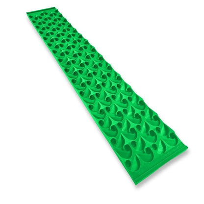 Angled view of 8X48 Dredge Dream Mat showcasing green textured capture pockets with a white background