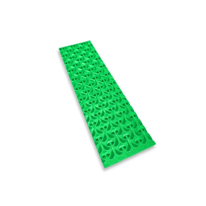 Angled view of Buddy Sluice Mat showcasing its bright green textured surface with a white background