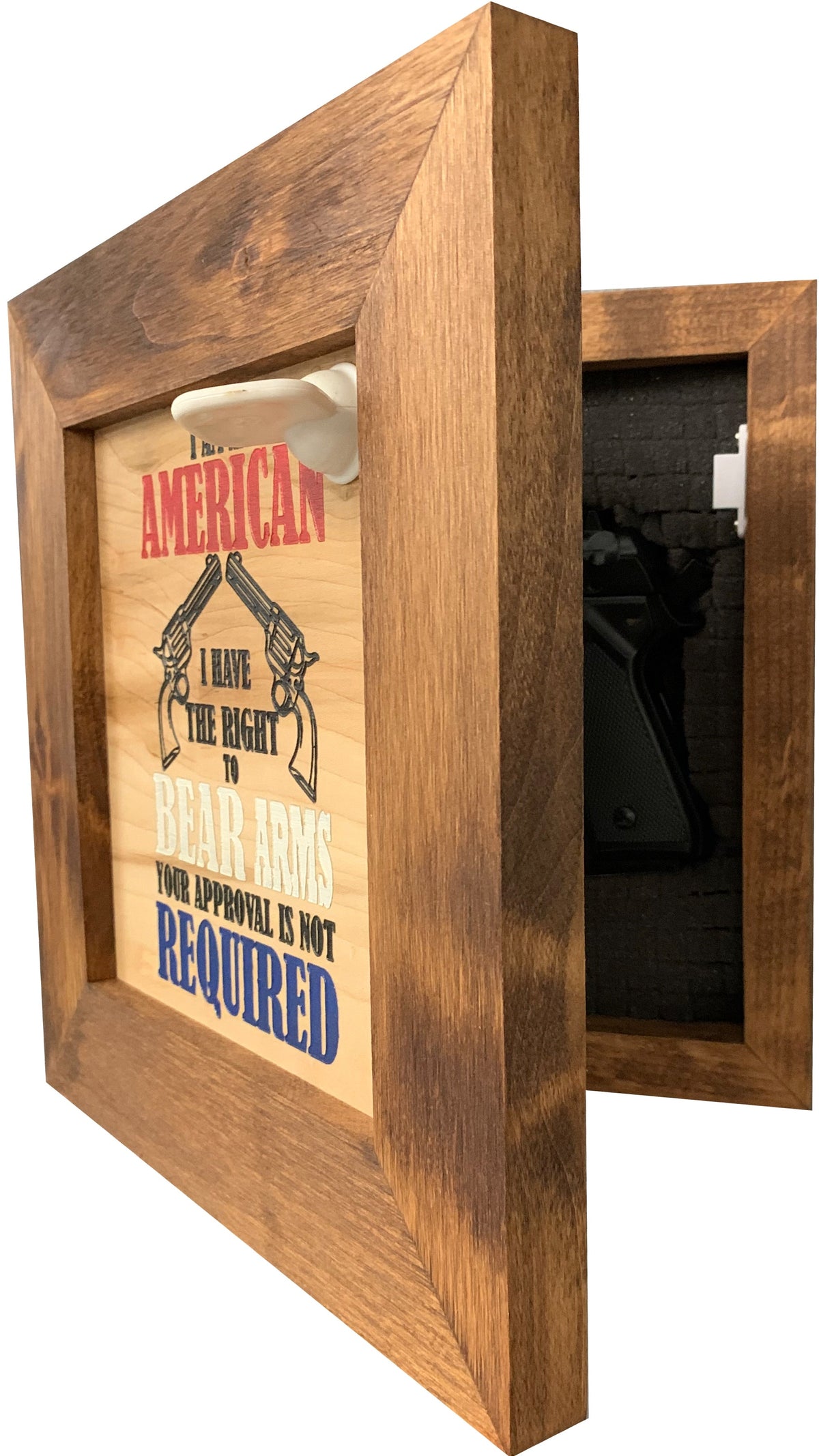 Wooden frame secret gun safe with hinged door open, revealing foam interior holding a black handgun.
