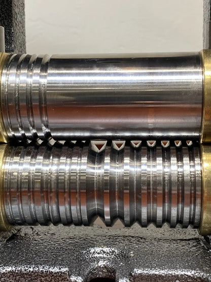 Close-up of Pepetools Triangle Mill showcasing grooved rollers for 0-8 gauge triangle, half-round, and square wire on textured metal base