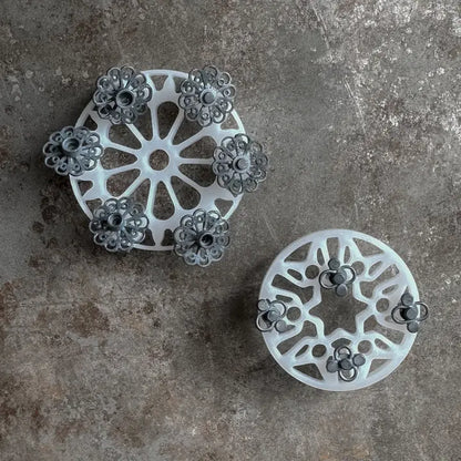 Top view of Tumble Wheels set of 3 by Rosy Revolver and Jessica Jordan Cote showing cutout wheel designs on gray surface